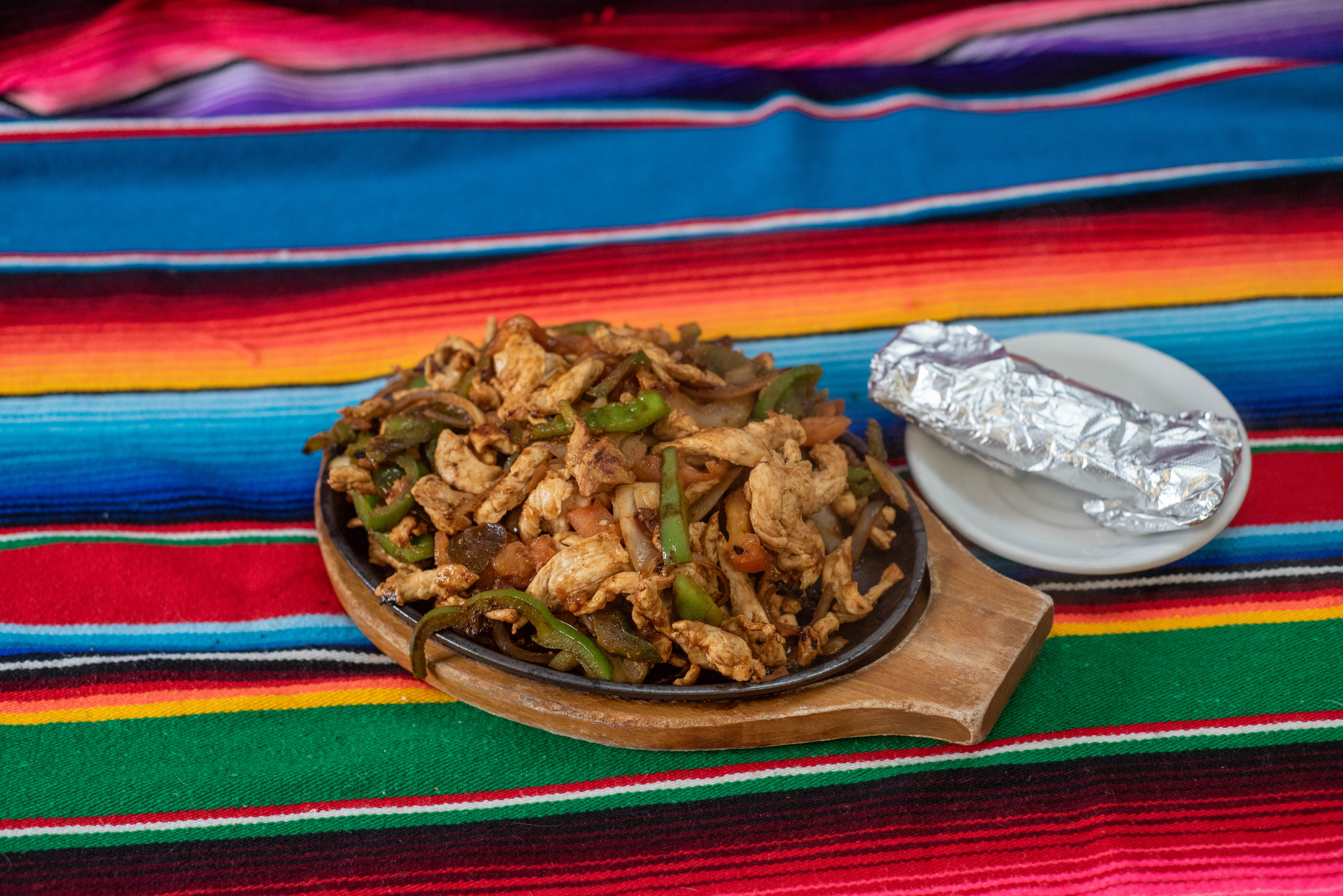 Chicken fajitas on sizzling skillet